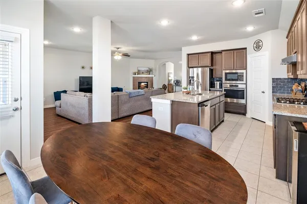 a living room with kitchen island furniture and a wooden floor