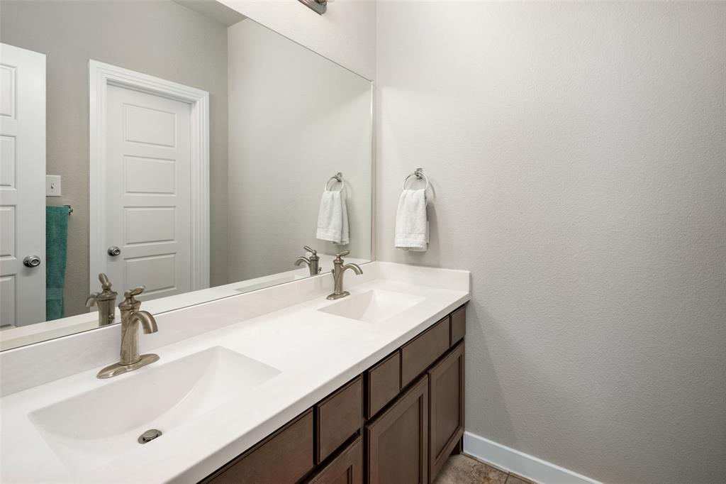 4209 Switchgrass Street Celina, TX 75009 - Photo 10 of 18 a bathroom with a sink and a mirror