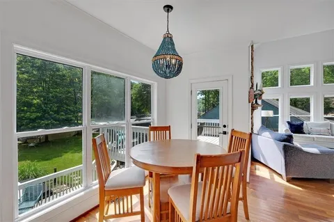 a view of a dining room with furniture window and wooden floor