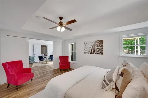 a bedroom with a bed and a chandelier