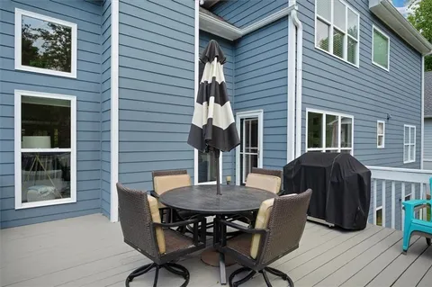 a view of a house with backyard sitting area and garden