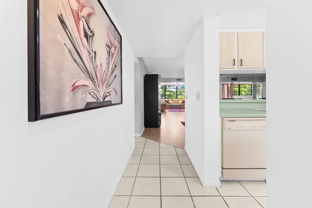 a view of a hallway to closet with wooden floor