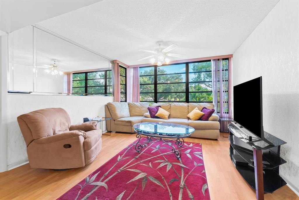 1717 Whitehall Drive, Unit 205 Davie, FL 33324 - Photo 8 of 18 a living room with furniture and a flat screen tv