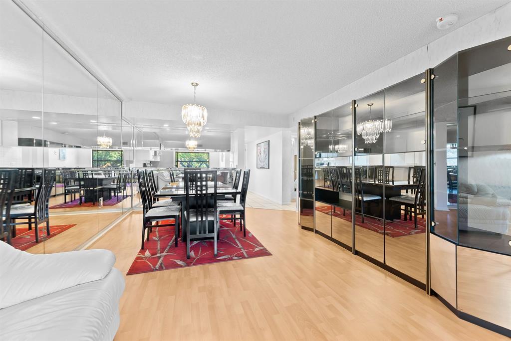 1717 Whitehall Drive, Unit 205 Davie, FL 33324 - Photo 9 of 18 a dining room with furniture and a chandelier