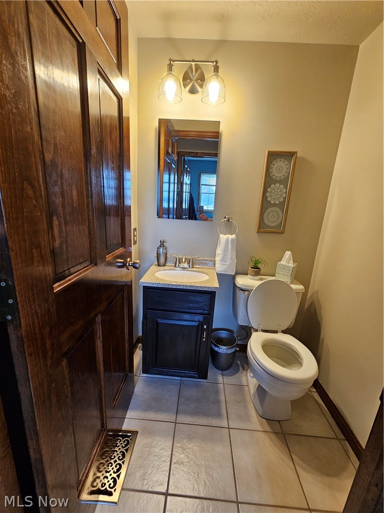 5100 Pierce Road Northwest Warren, OH 44481 - Photo 19 of 26 Bathroom with vanity, toilet, a textured ceiling, and tile floors