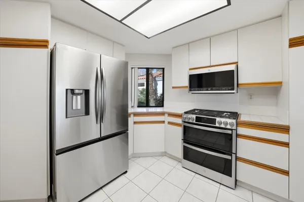 a kitchen with stainless steel appliances a refrigerator stove and microwave