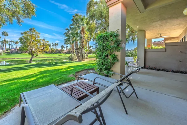 a view of a backyard with sitting area