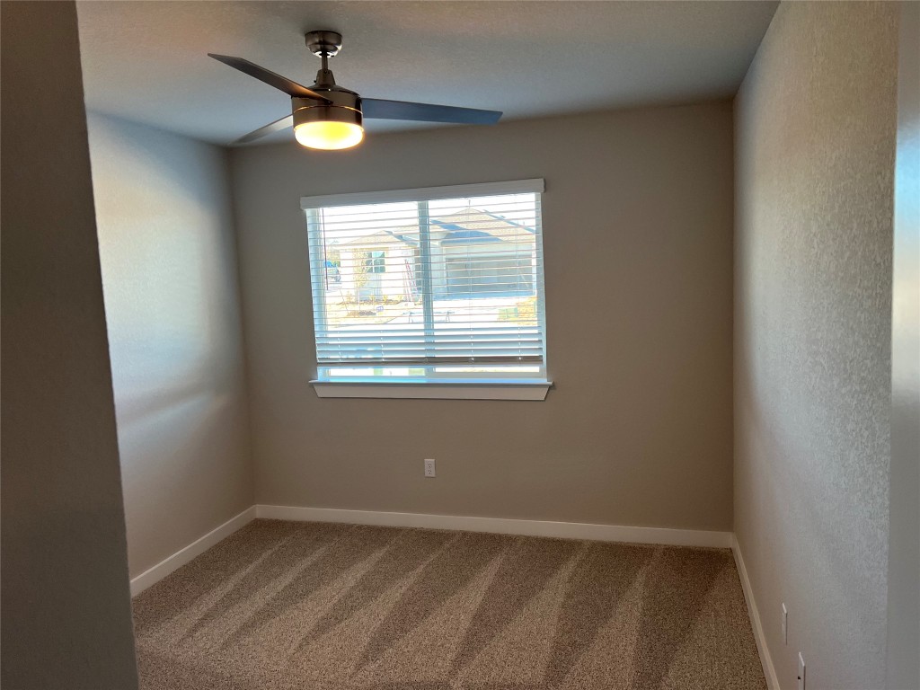 404 Coda Crossing Georgetown, TX 78633 - Photo 11 of 15 Unfurnished room featuring light colored carpet and a ceiling fan