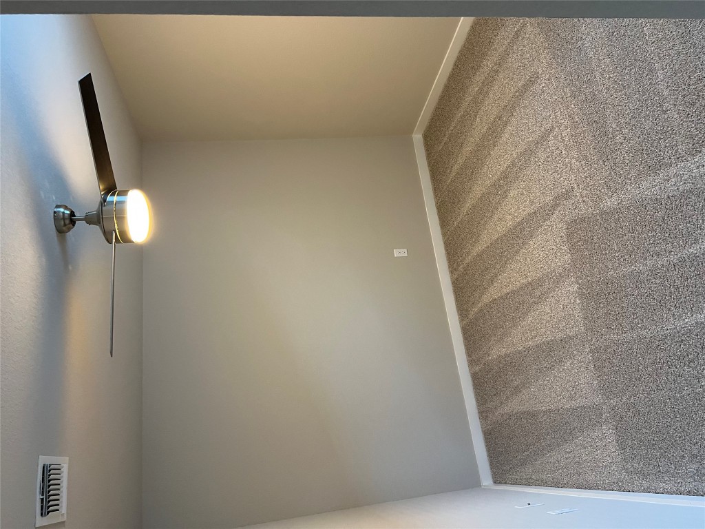 404 Coda Crossing Georgetown, TX 78633 - Photo 13 of 15 Empty room with light carpet and ceiling fan