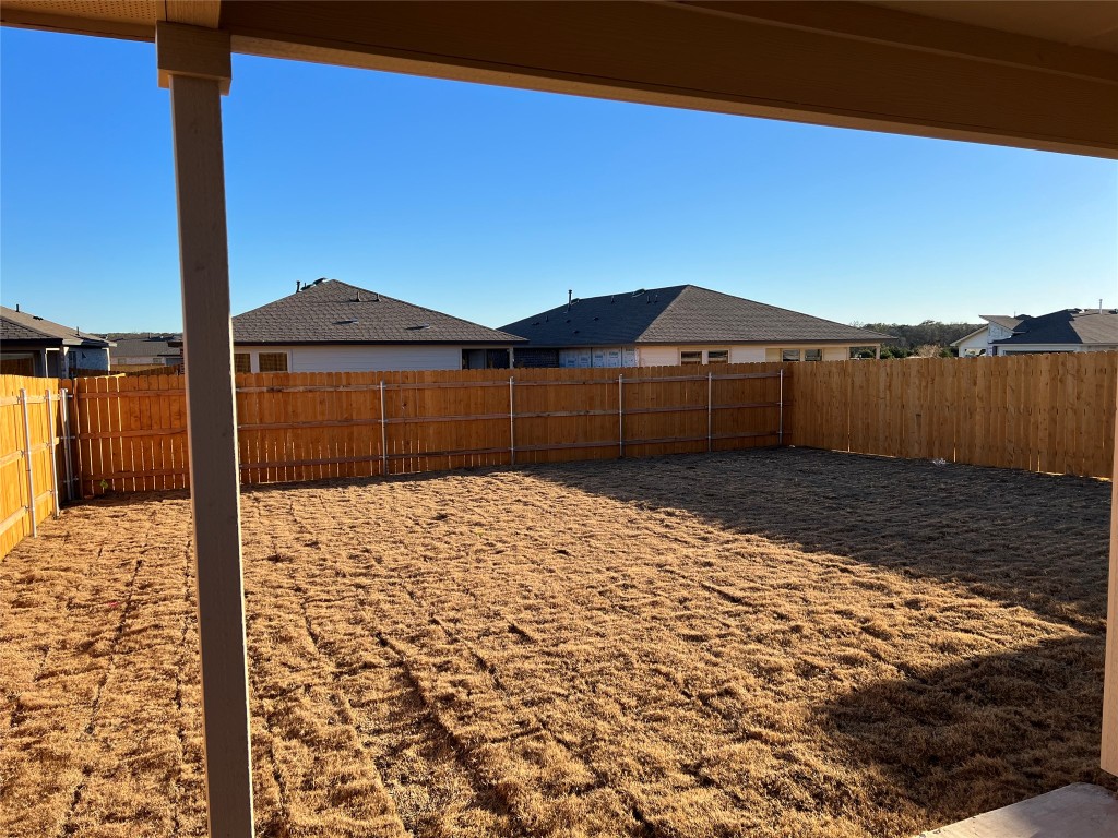 404 Coda Crossing Georgetown, TX 78633 - Photo 15 of 15 Fenced backyard with a residential view