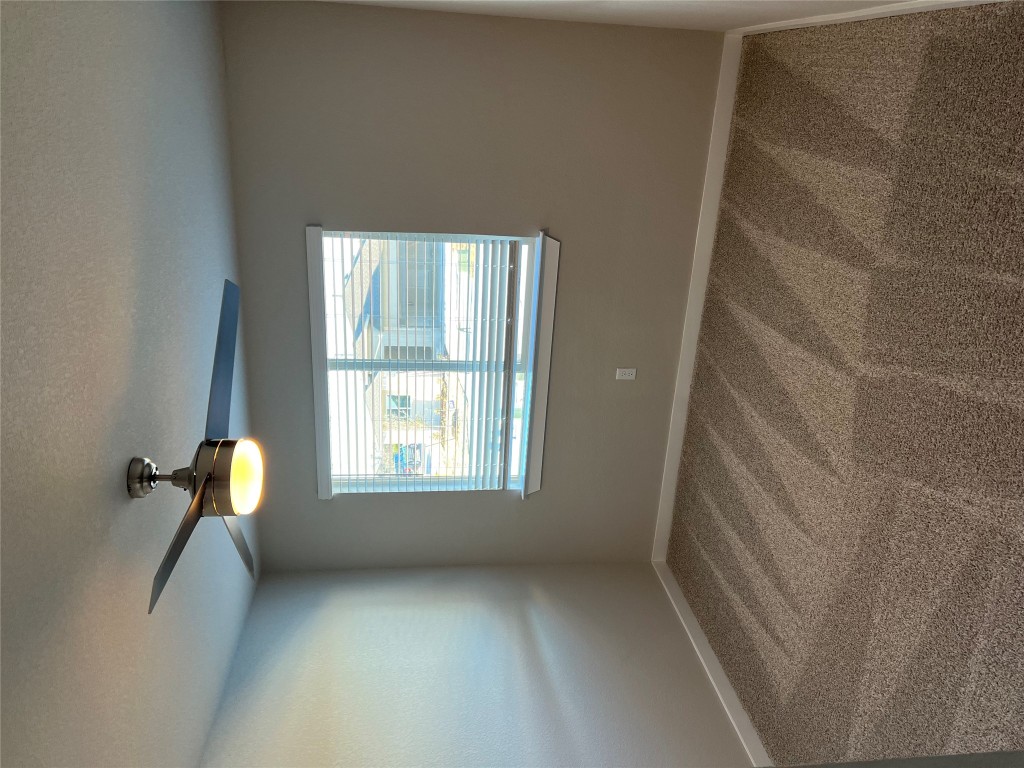 404 Coda Crossing Georgetown, TX 78633 - Photo 10 of 15 Spare room with carpet, ceiling fan, and a textured ceiling