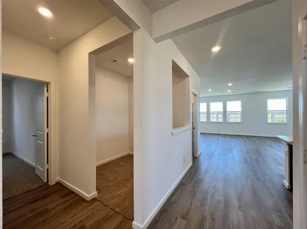 a view of hallway with wooden floor