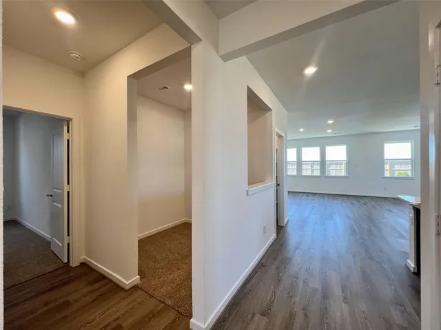 a view of hallway with wooden floor