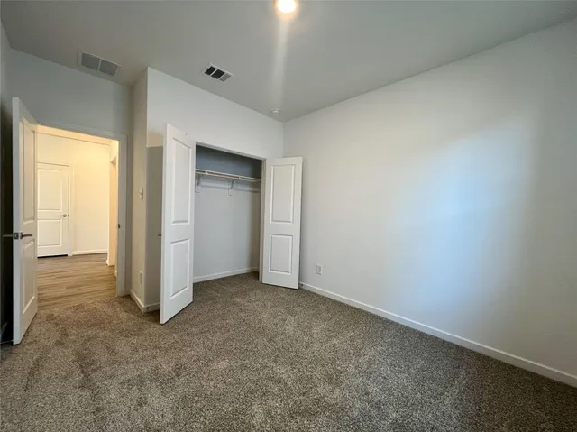 an empty room with closet area