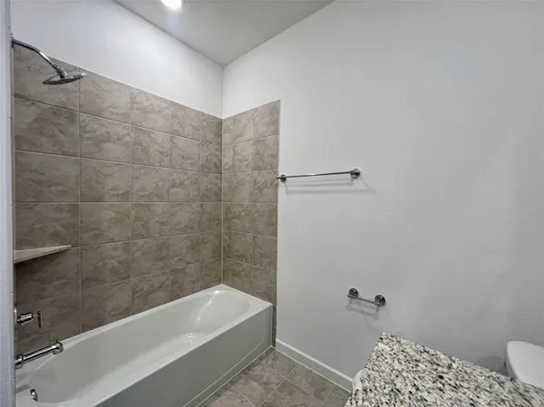 a bathroom with a bathtub and shower