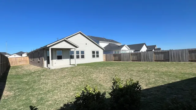 a swimming pool with outdoor seating and yard