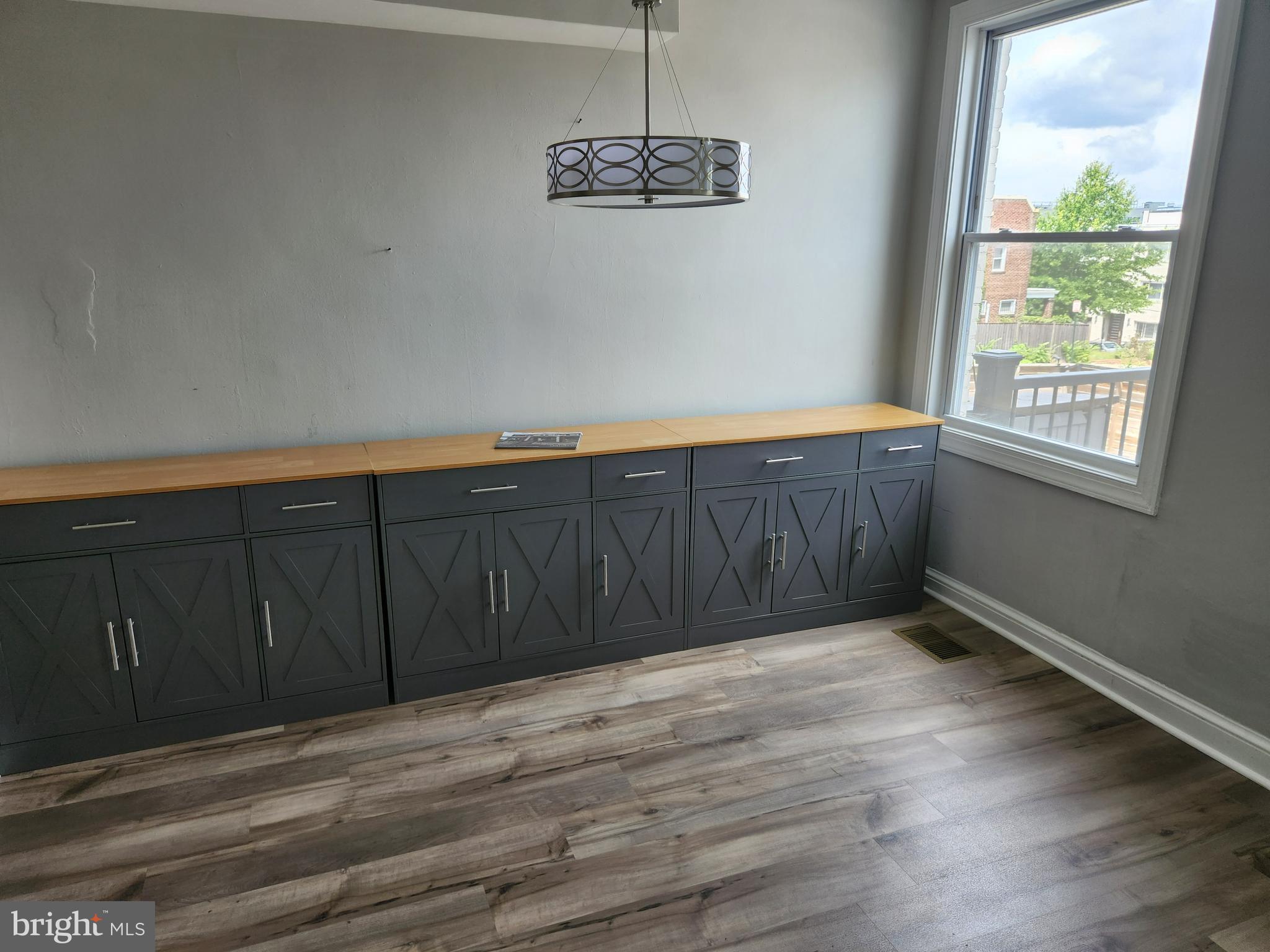 1702 Lang Place Northeast Washington, DC 20002 - Photo 11 of 36 a view of a room with wooden floor and a window