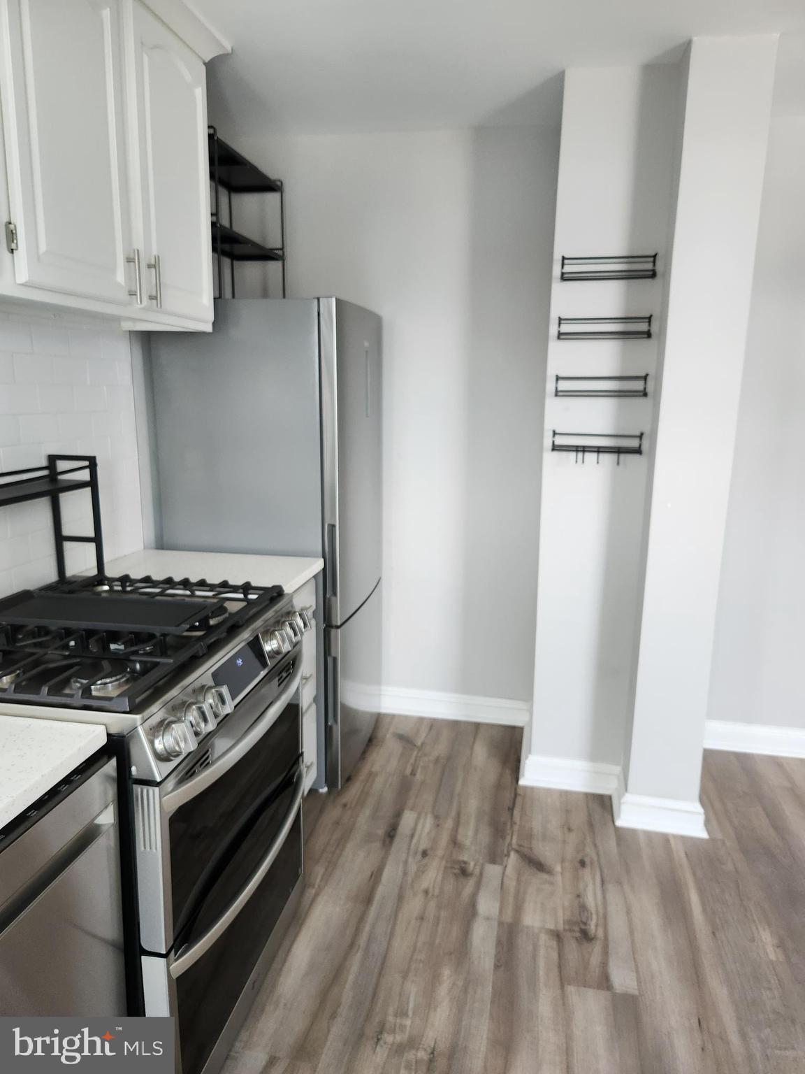 1702 Lang Place Northeast Washington, DC 20002 - Photo 13 of 36 a kitchen with wooden floor and a stove