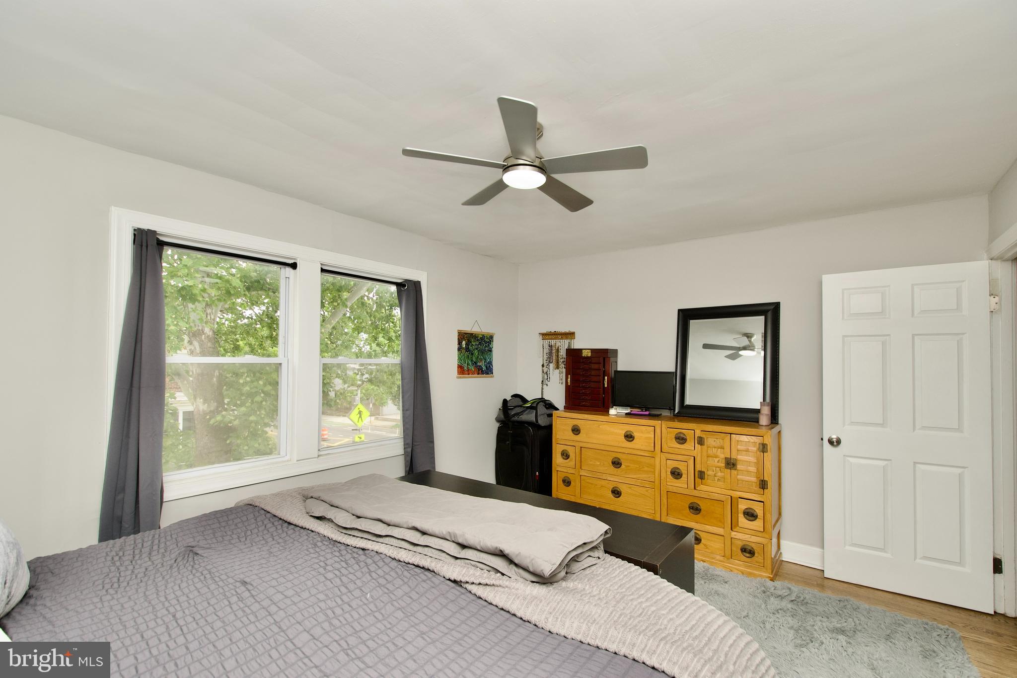 1702 Lang Place Northeast Washington, DC 20002 - Photo 18 of 36 a bedroom with a bed and wooden floor