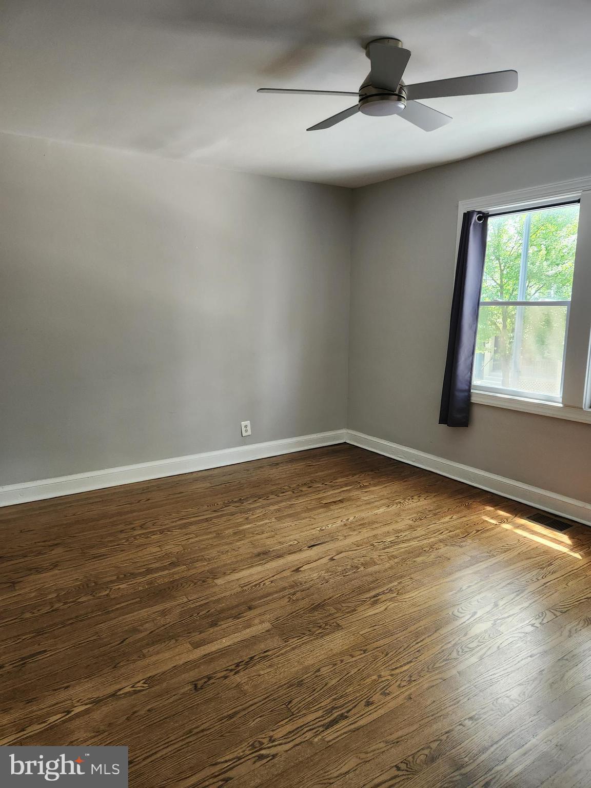 1702 Lang Place Northeast Washington, DC 20002 - Photo 19 of 36 wooden floor in an empty room with a window