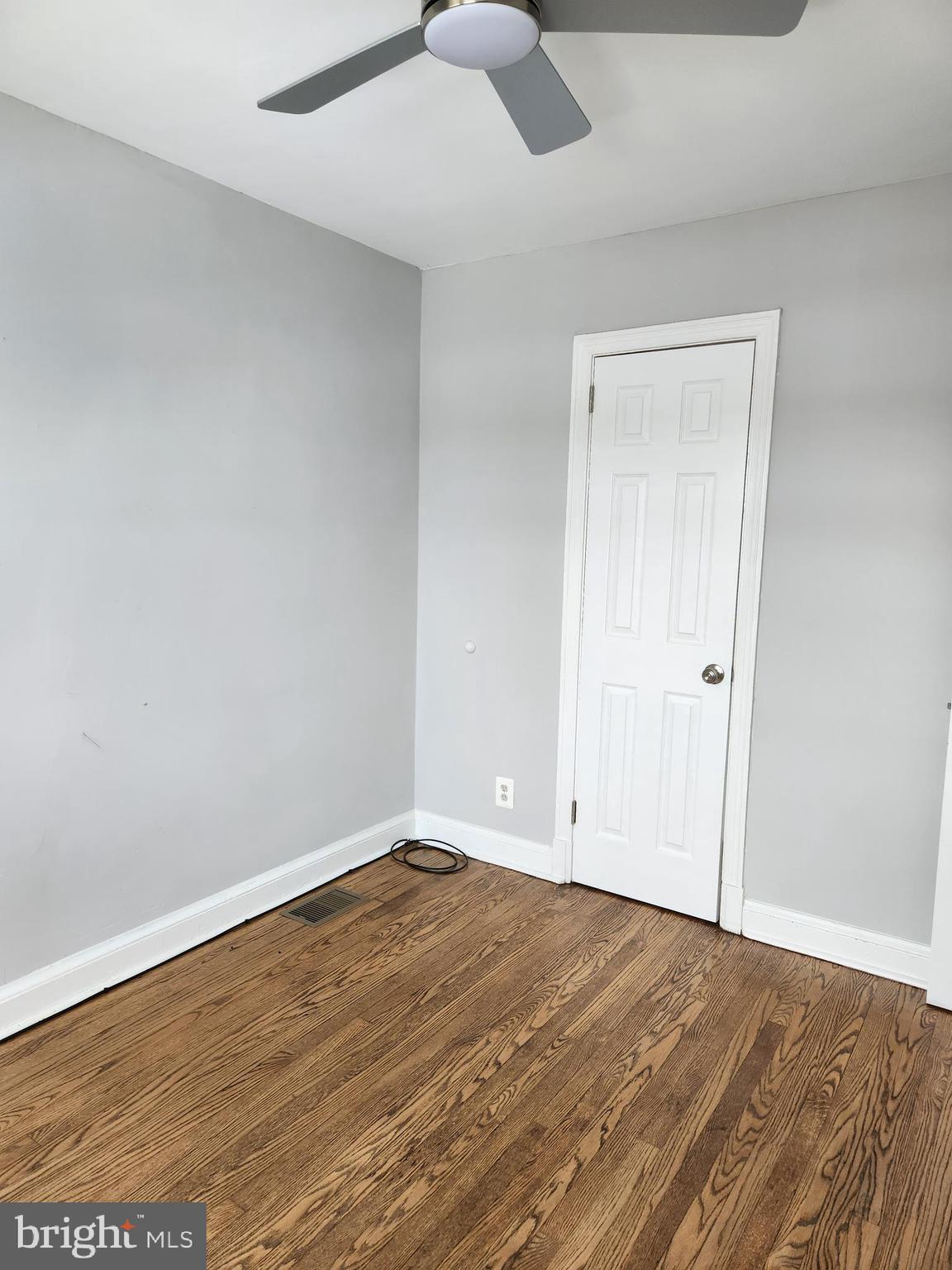 1702 Lang Place Northeast Washington, DC 20002 - Photo 21 of 36 an empty room with wooden floor and natural light