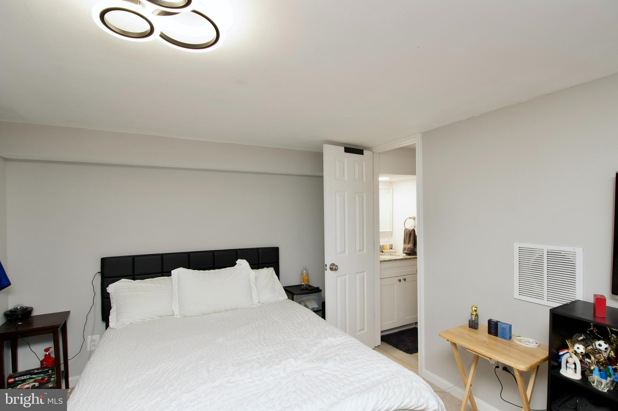 1702 Lang Place Northeast Washington, DC 20002 - Photo 22 of 36 a bedroom with a bed and window