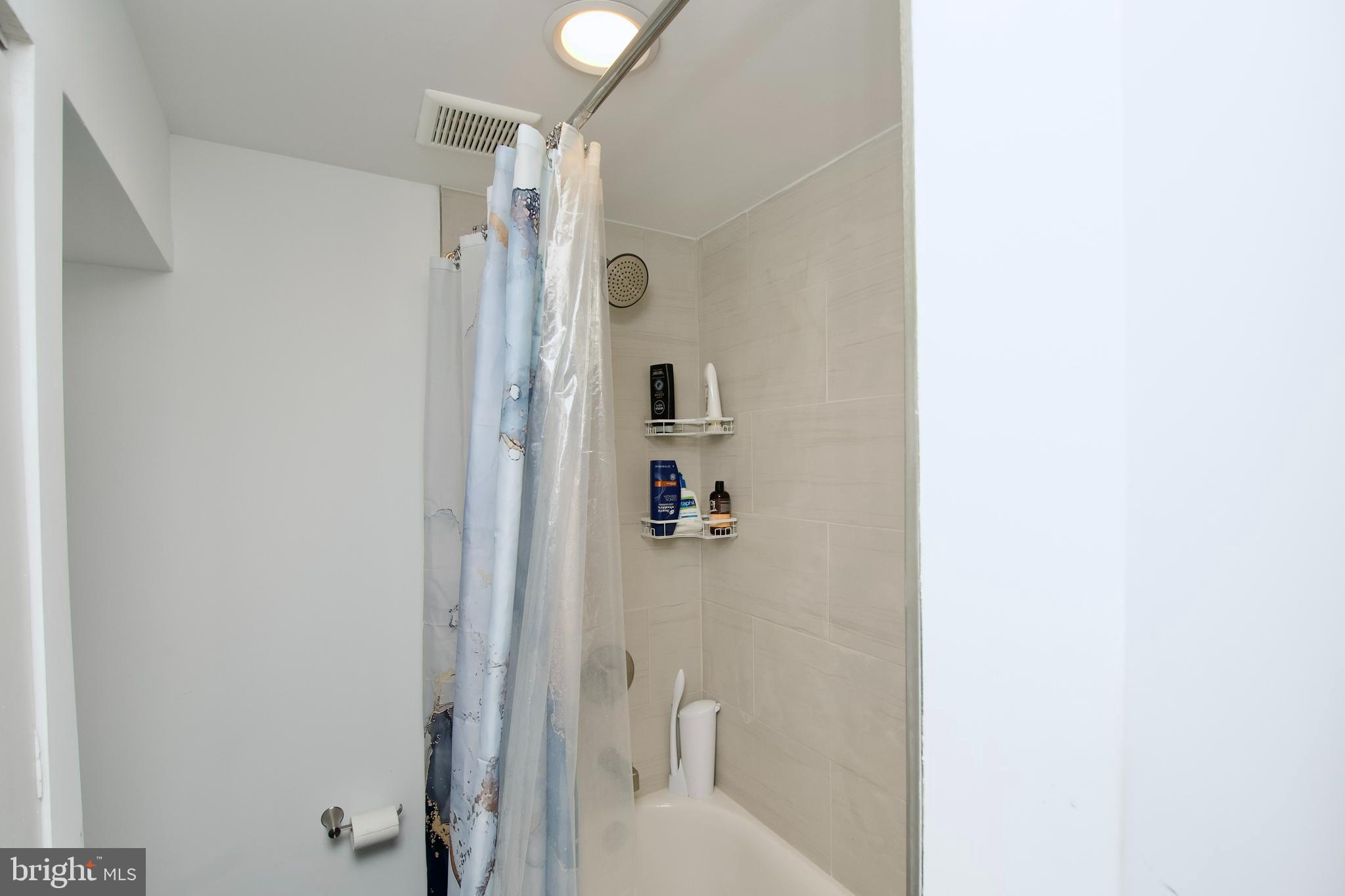 1702 Lang Place Northeast Washington, DC 20002 - Photo 27 of 36 a bathroom with a shower and a sink