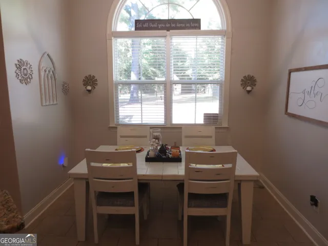 a dining room with furniture and window