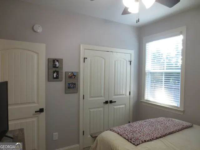 a bedroom with a bed and a flat screen tv