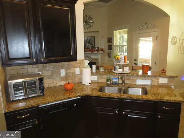 a kitchen with sink and refrigerator