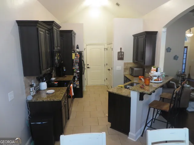 a bathroom with a sink vanity granite and a mirror