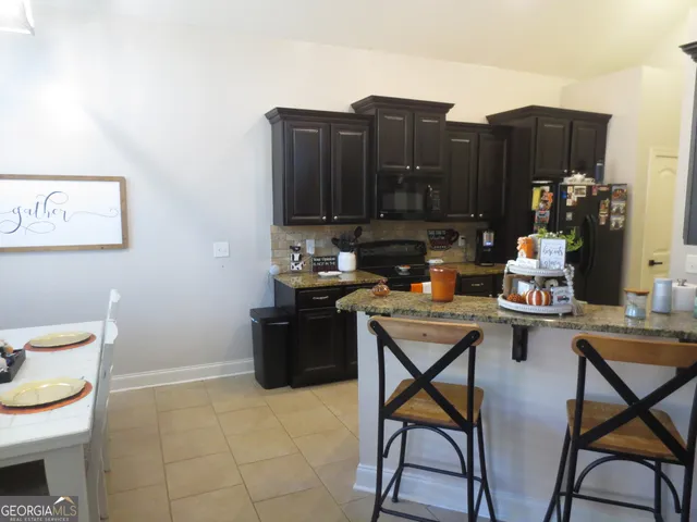 a living room with furniture a air conditioner and a stove