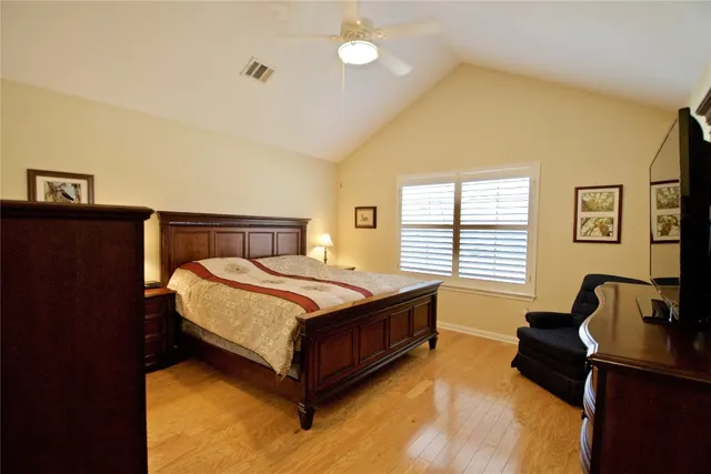 a bedroom with a bed window and couch
