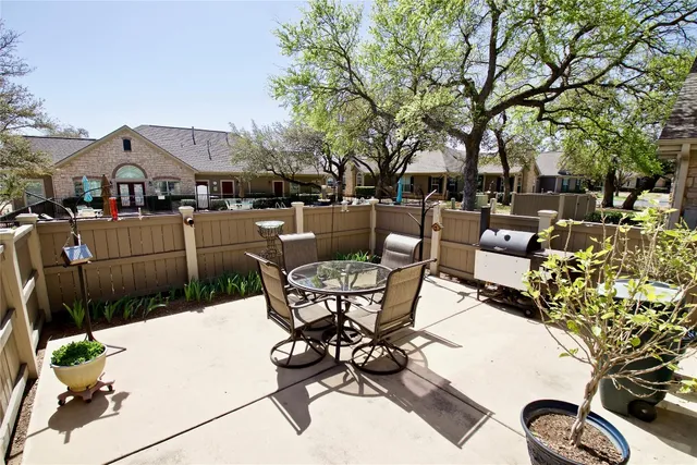 a view of a patio with table and chairs and potted plants