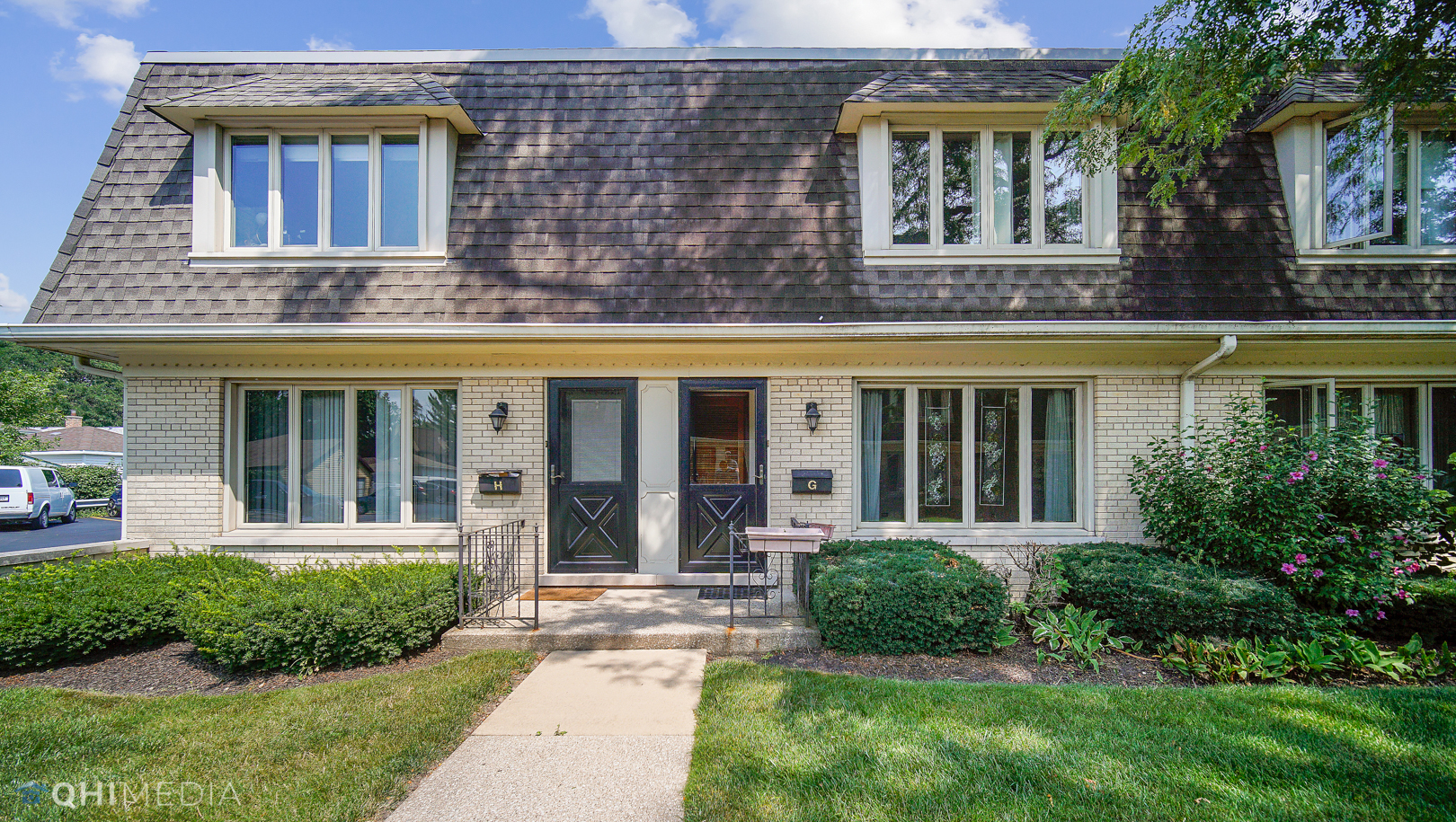2128 West 111th Street, Unit G Chicago, IL 60643 - Photo 2 of 20 front view of a brick house with a yard