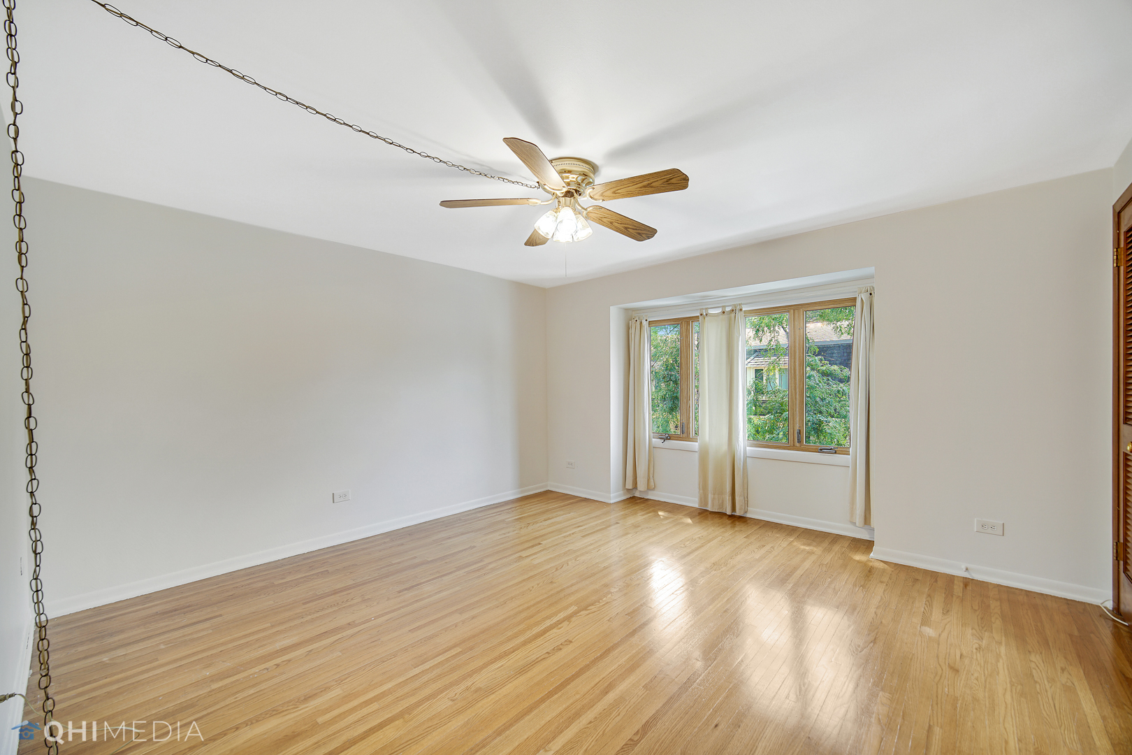 2128 West 111th Street, Unit G Chicago, IL 60643 - Photo 12 of 20 wooden floor in an empty room with a window