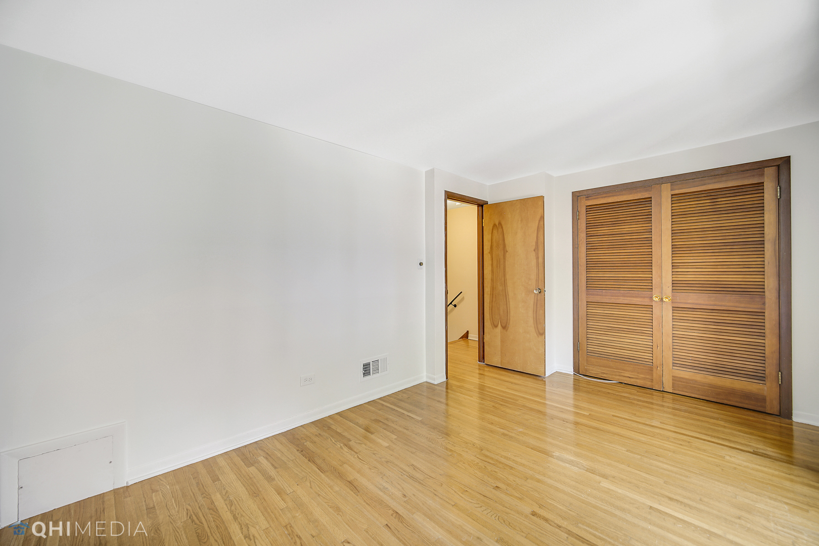 2128 West 111th Street, Unit G Chicago, IL 60643 - Photo 13 of 20 a view of empty room with wooden floor and fan