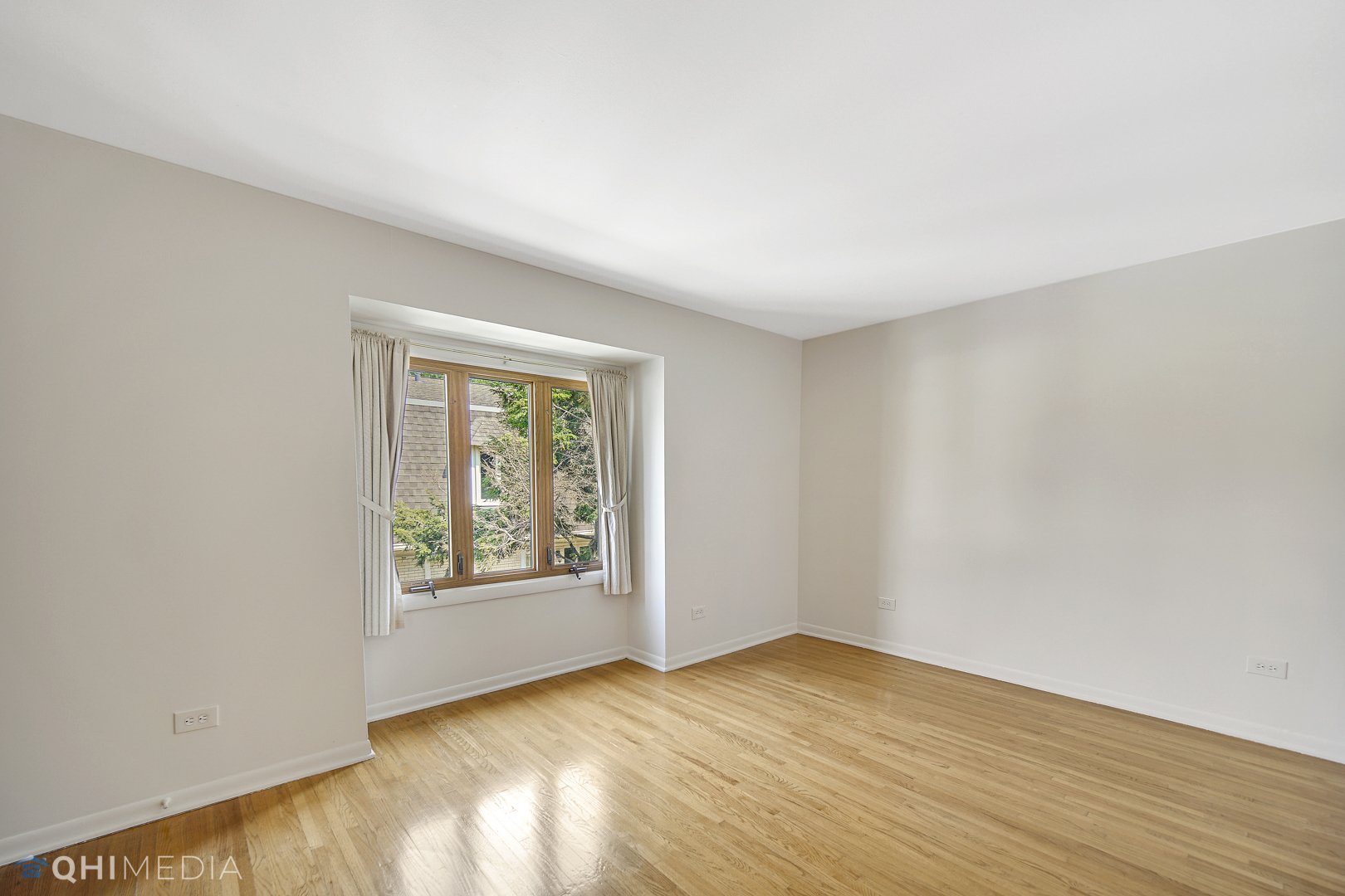 2128 West 111th Street, Unit G Chicago, IL 60643 - Photo 14 of 20 an empty room with wooden floor and windows