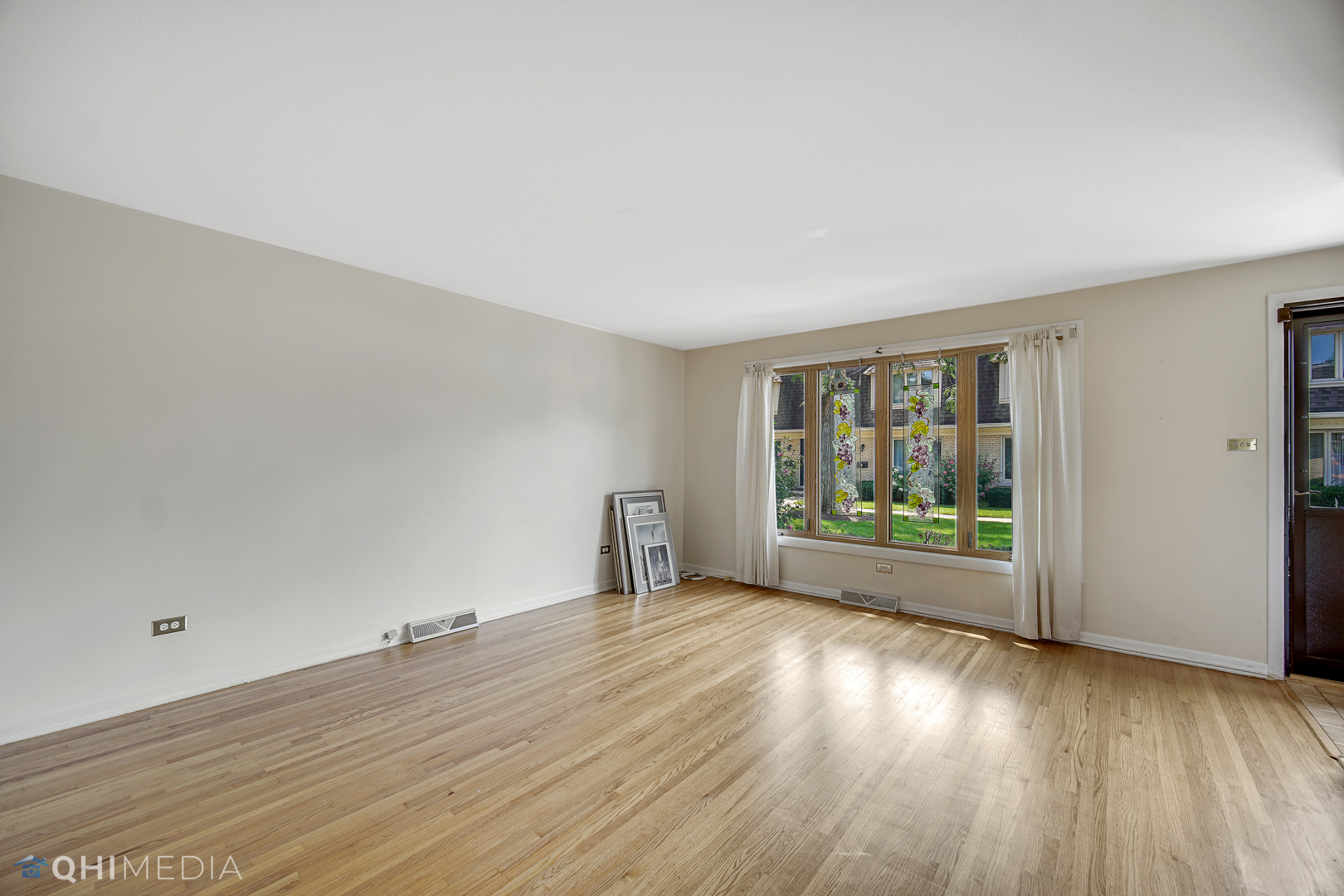 2128 West 111th Street, Unit G Chicago, IL 60643 - Photo 4 of 20 wooden floor in an empty room with a window