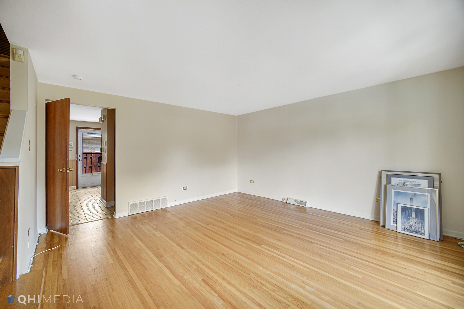 2128 West 111th Street, Unit G Chicago, IL 60643 - Photo 6 of 20 an empty room with wooden floor and windows