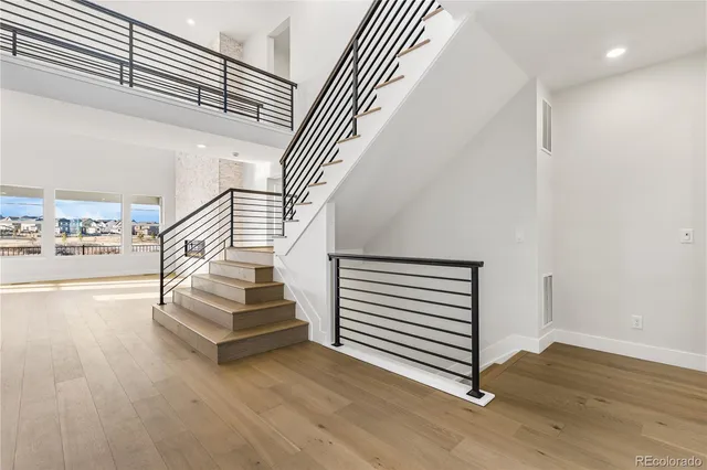 a view of entryway and hall with wooden floor
