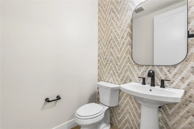 a spacious bathroom with a tub sink and mirror