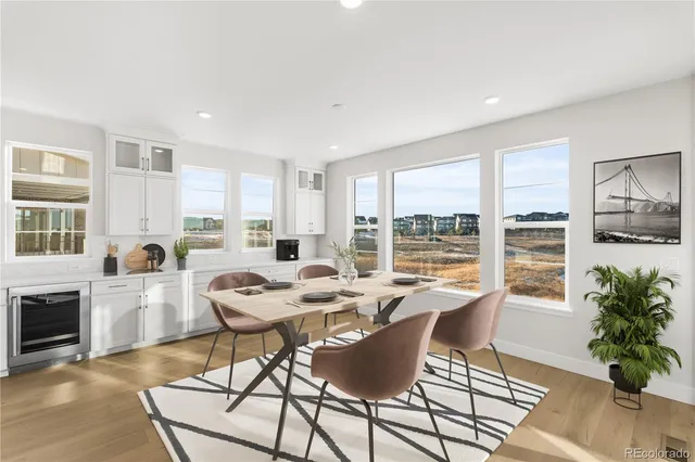 a dining room with furniture window and wooden floor