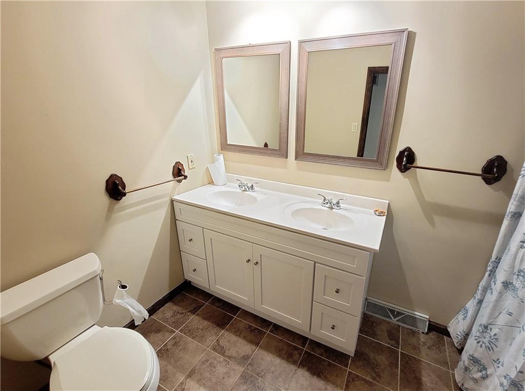 130 Pflugh Road Butler, PA 16001 - Photo 11 of 25 a bathroom with a granite countertop toilet sink and mirror