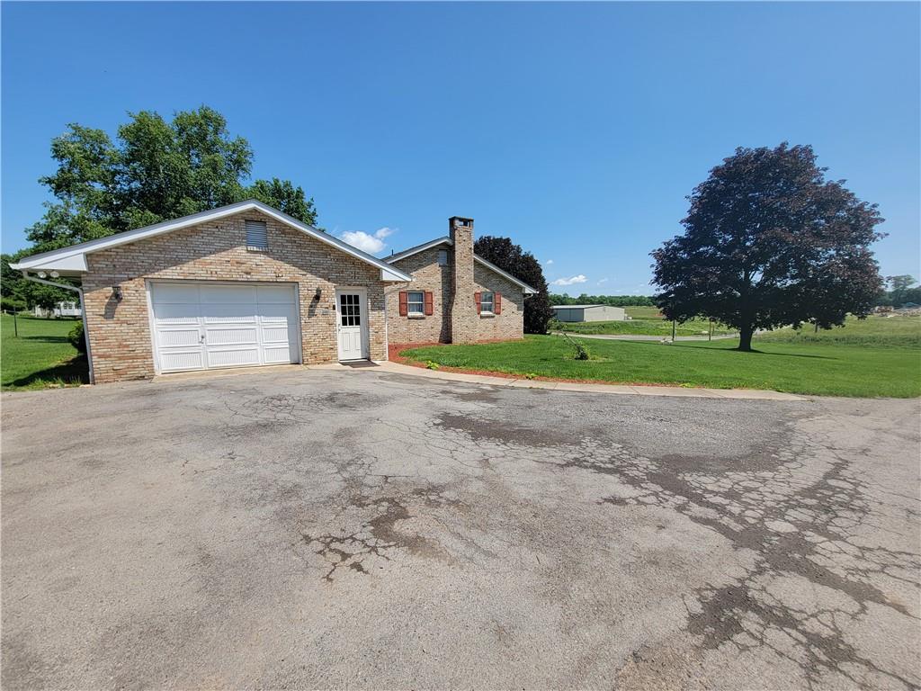 130 Pflugh Road Butler, PA 16001 - Photo 2 of 25 a front view of a house with a yard and garage