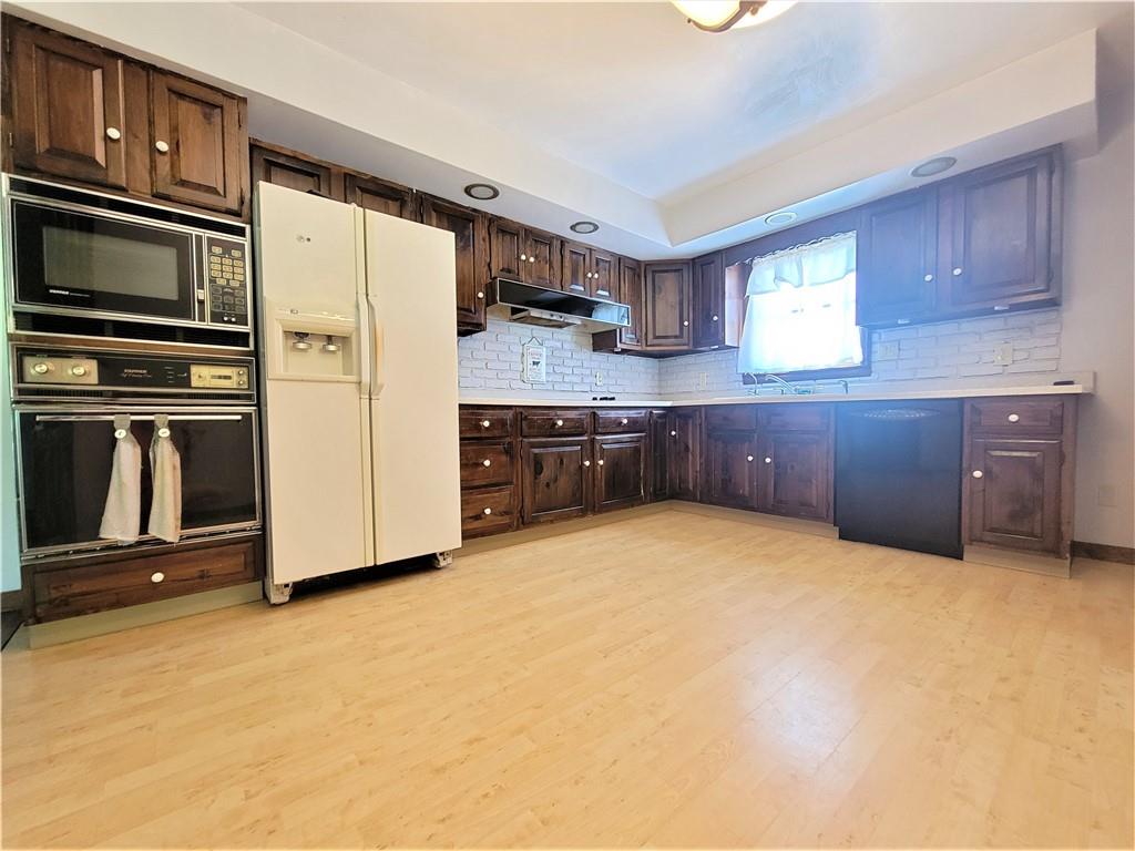 130 Pflugh Road Butler, PA 16001 - Photo 4 of 25 a kitchen with stainless steel appliances a refrigerator and wooden cabinets