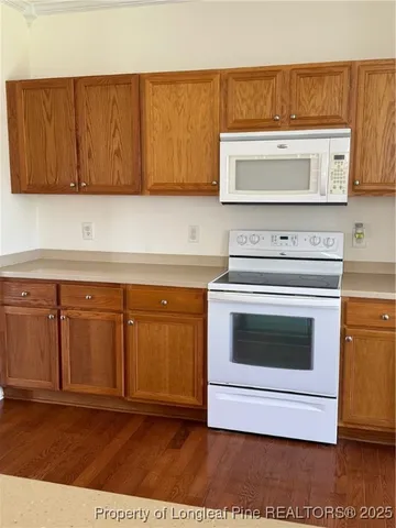a stove top oven sitting inside of a kitchen