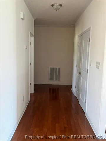 a view of hallway with wooden floor