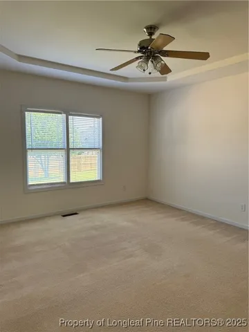 a view of a room with a ceiling fan