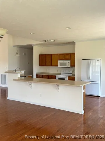 a view of kitchen with stainless steel appliances cabinets